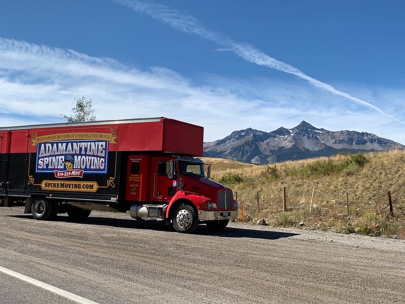 moving truck on highway with mountains in background