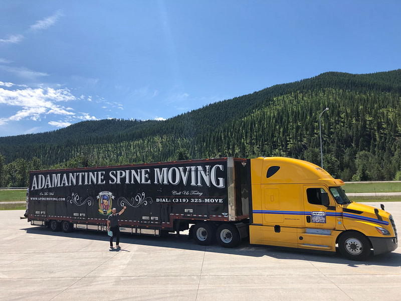 moving truck with scenic green mountains in background