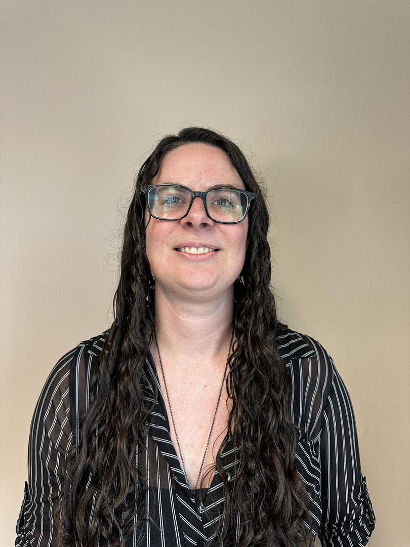 Smiling woman with glasses and striped blouse, portrait