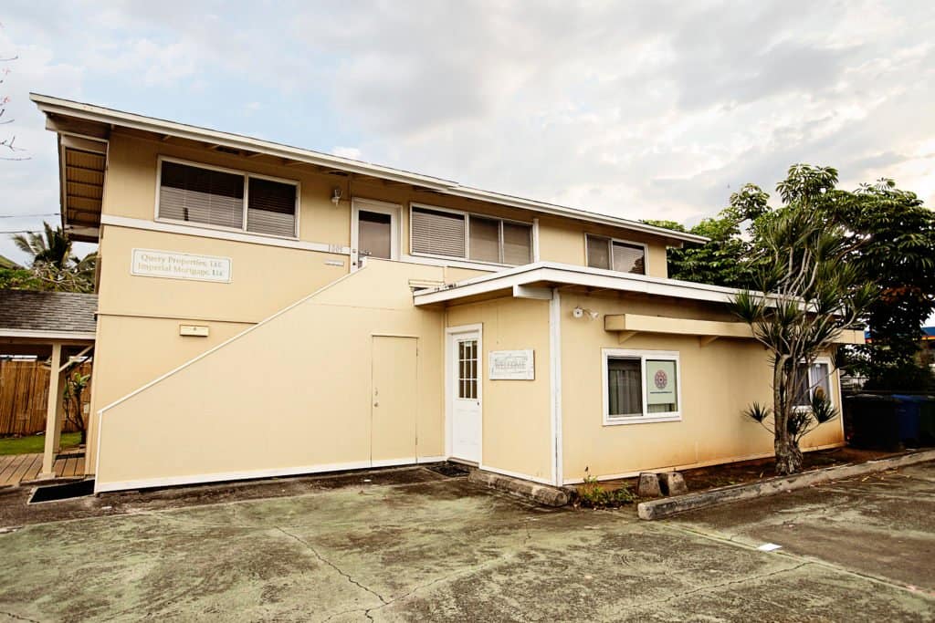 exterior of yellow medical clinic from parking lot