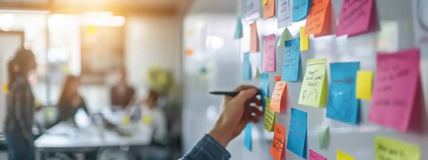 a team collaborating at a modern office, brainstorming and strategizing around a whiteboard filled with colorful sticky notes and charts.